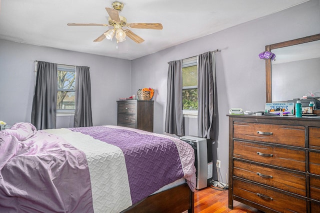 bedroom with light wood-style flooring and a ceiling fan