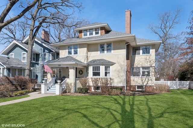 traditional style home featuring fence, a shingled roof, stucco siding, a front lawn, and a chimney