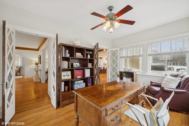 office area featuring light wood-style floors, baseboards, and ceiling fan