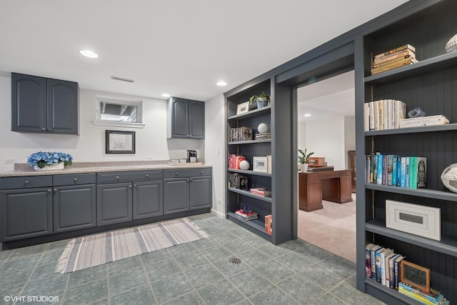 kitchen with open shelves, recessed lighting, gray cabinets, and light countertops