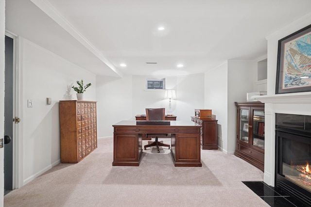 home office featuring recessed lighting, a fireplace with flush hearth, light colored carpet, and baseboards