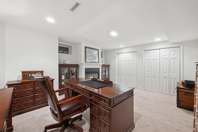 home office with recessed lighting, visible vents, light carpet, and a glass covered fireplace