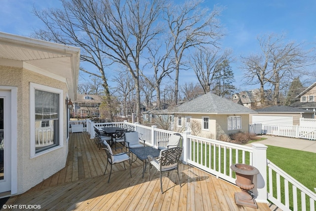 wooden deck with outdoor dining area, a residential view, and a yard