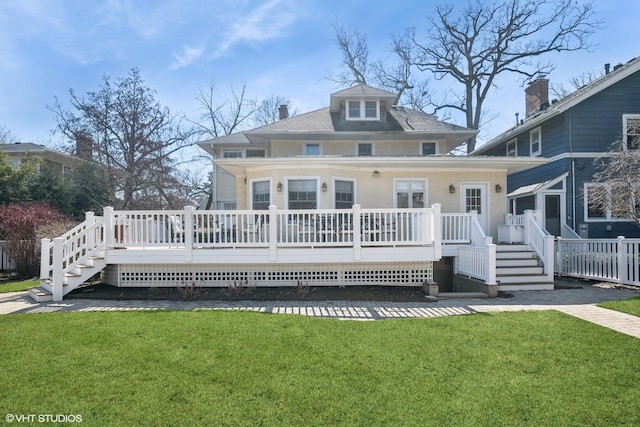 view of front of house featuring a front yard and a wooden deck