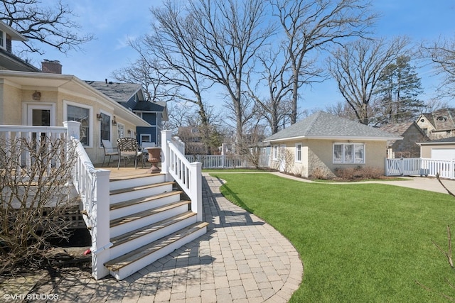 view of yard with an outbuilding, fence, and a wooden deck