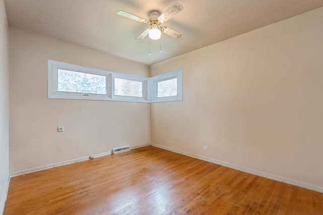 empty room with visible vents, ceiling fan, baseboards, and light wood-style floors