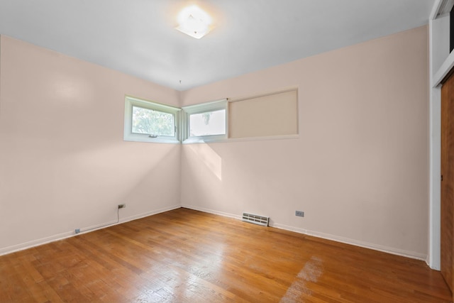 unfurnished room with visible vents, baseboards, and light wood finished floors