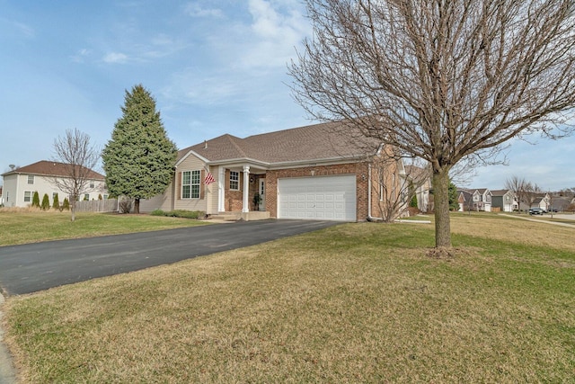 ranch-style house featuring a front yard, a garage, brick siding, and aphalt driveway