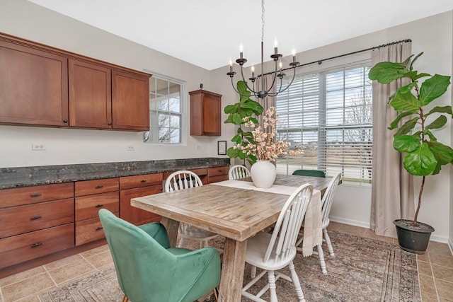dining space with a notable chandelier and baseboards