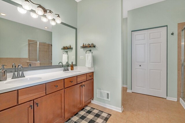 full bath with a sink, a shower stall, and visible vents