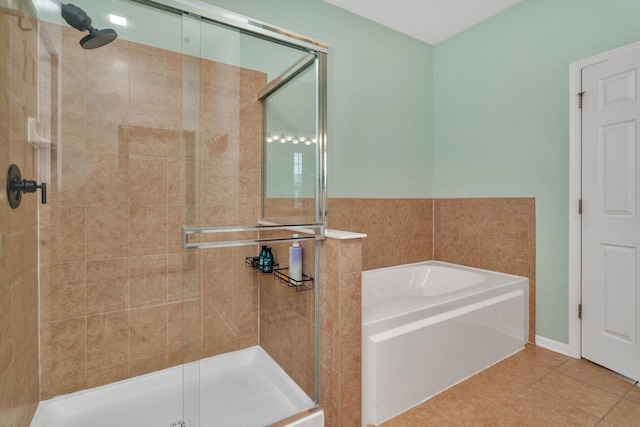 full bathroom featuring tile patterned floors, a stall shower, and a garden tub