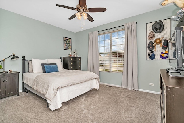 bedroom featuring light carpet, baseboards, visible vents, and a ceiling fan