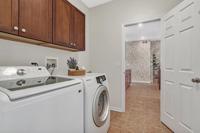 laundry area featuring visible vents, baseboards, wallpapered walls, cabinet space, and washer and clothes dryer