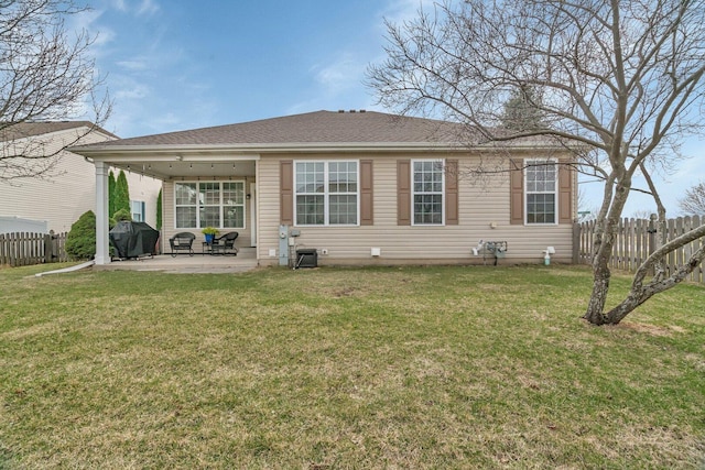 back of house with fence, a yard, and a patio area