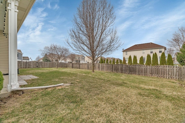 view of yard with a fenced backyard and a residential view