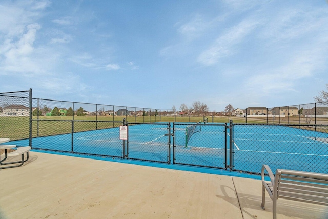 view of sport court featuring a gate and fence
