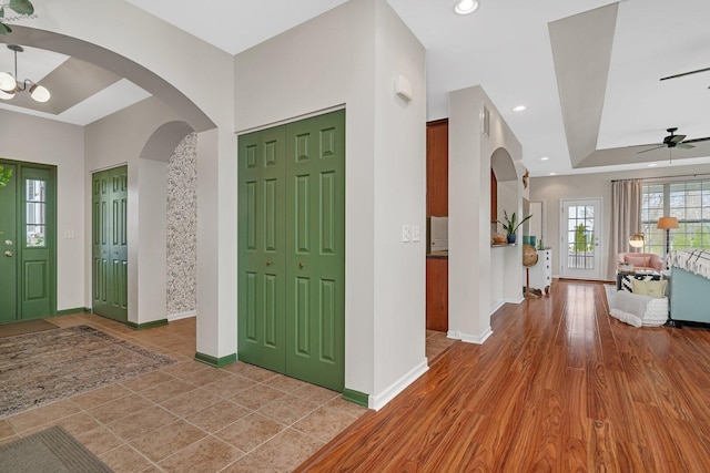 foyer with arched walkways, baseboards, recessed lighting, and a ceiling fan