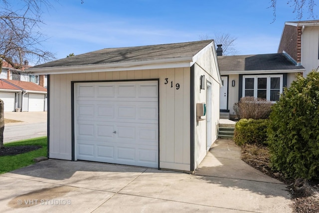 garage with concrete driveway