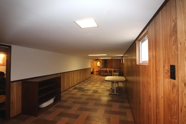 corridor with wood walls and wainscoting