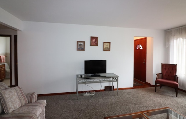 carpeted living area with baseboards