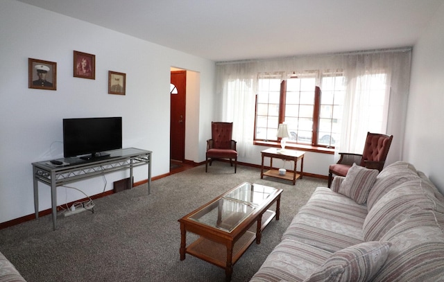 carpeted living area featuring baseboards