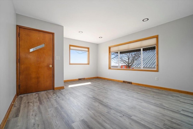 unfurnished room featuring recessed lighting, visible vents, baseboards, and wood finished floors