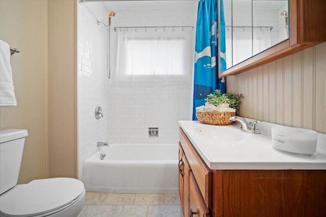 full bathroom featuring tile patterned floors, shower / bath combo with shower curtain, toilet, and vanity