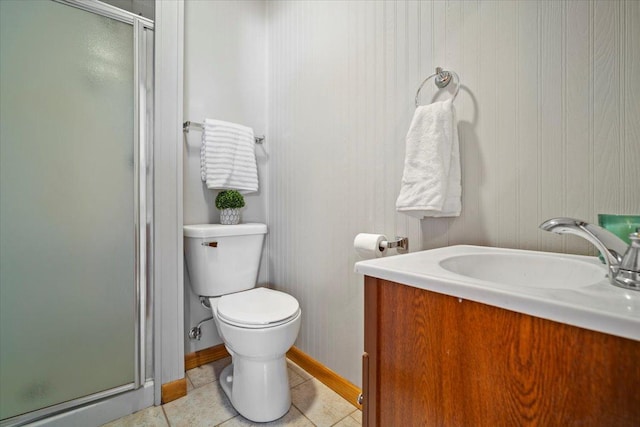 bathroom with tile patterned floors, toilet, a stall shower, and vanity