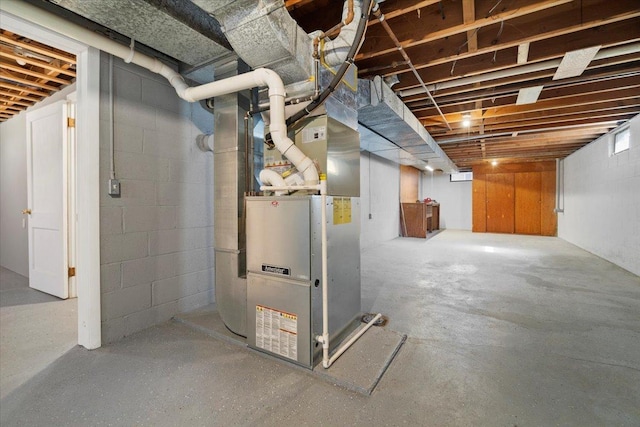 unfinished basement featuring heating unit