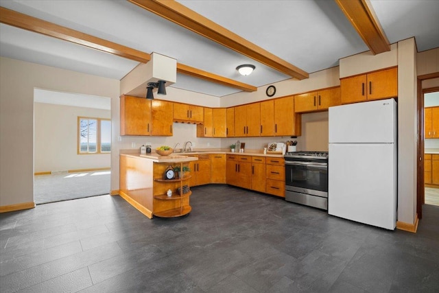 kitchen featuring beamed ceiling, freestanding refrigerator, baseboards, light countertops, and gas range