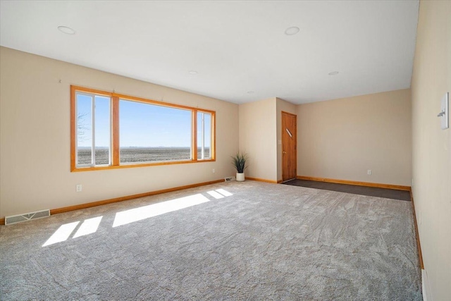 unfurnished room featuring visible vents, baseboards, and carpet floors