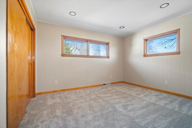 unfurnished bedroom with visible vents, carpet floors, and baseboards