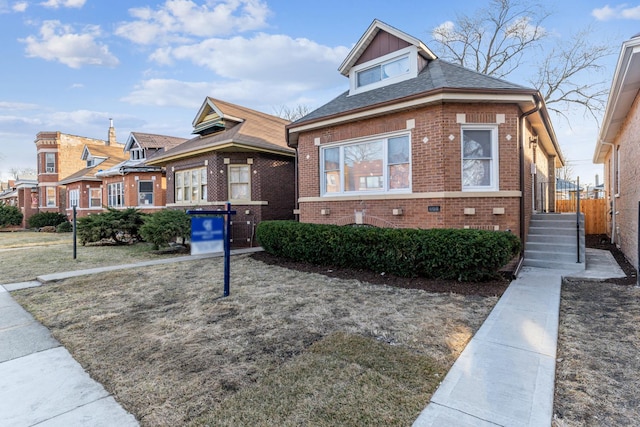 bungalow-style house with brick siding