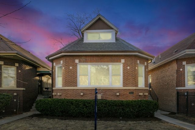 view of front of property featuring brick siding and a shingled roof