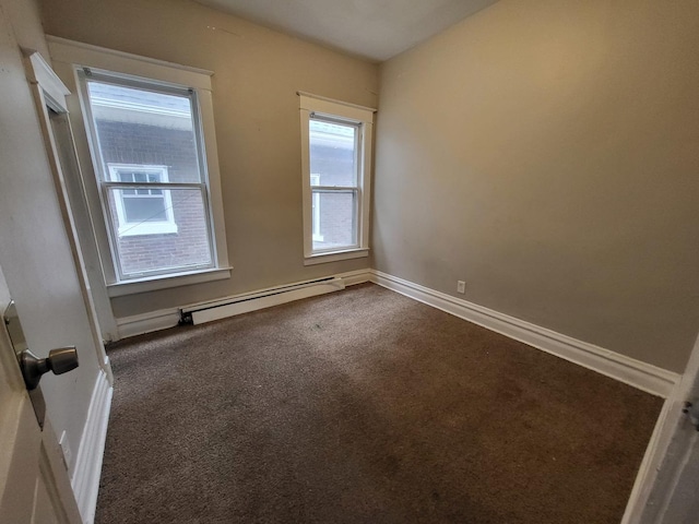 unfurnished room featuring baseboards, dark colored carpet, and baseboard heating