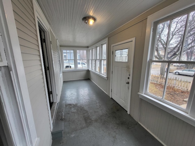 unfurnished sunroom featuring wood ceiling