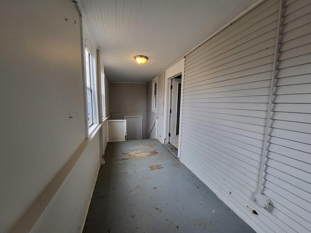 corridor with unfinished concrete floors