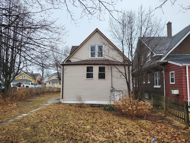 rear view of property with fence