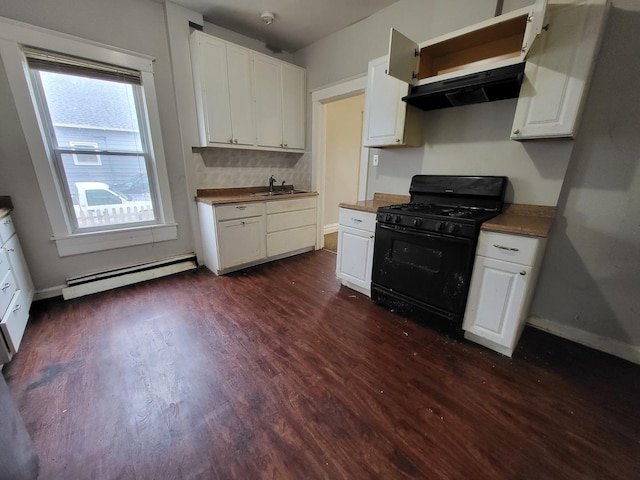 kitchen featuring dark wood-type flooring, a sink, under cabinet range hood, black gas stove, and baseboard heating