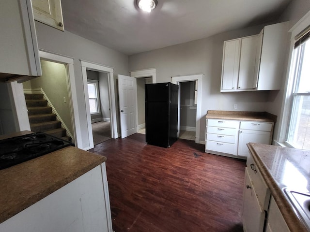 kitchen featuring cooktop, white cabinetry, dark wood finished floors, and freestanding refrigerator