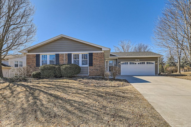 single story home featuring brick siding, an attached garage, and concrete driveway