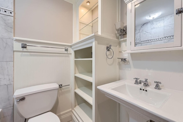 bathroom featuring toilet and a sink