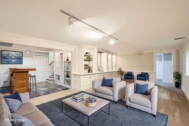 living area featuring visible vents, stairway, and crown molding