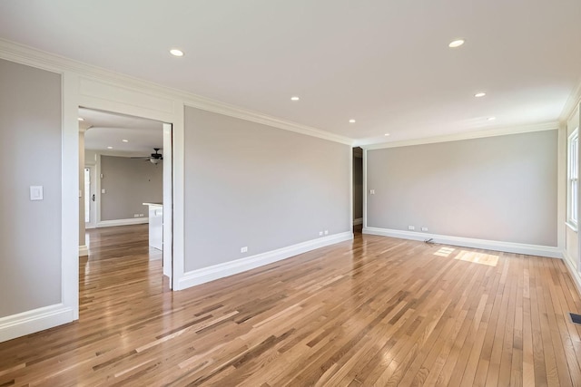 unfurnished room featuring ornamental molding, a ceiling fan, recessed lighting, light wood finished floors, and baseboards