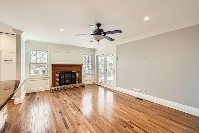 unfurnished living room with visible vents, ornamental molding, and a decorative wall