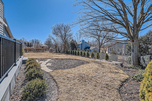 view of yard featuring a residential view and fence