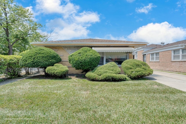 view of property exterior featuring a yard and brick siding