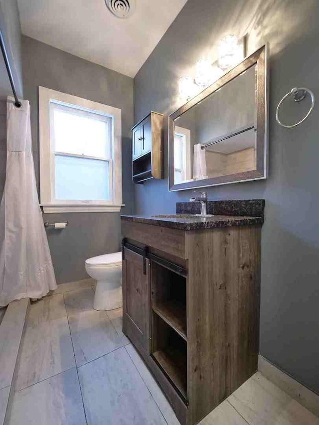 bathroom with visible vents, toilet, and vanity