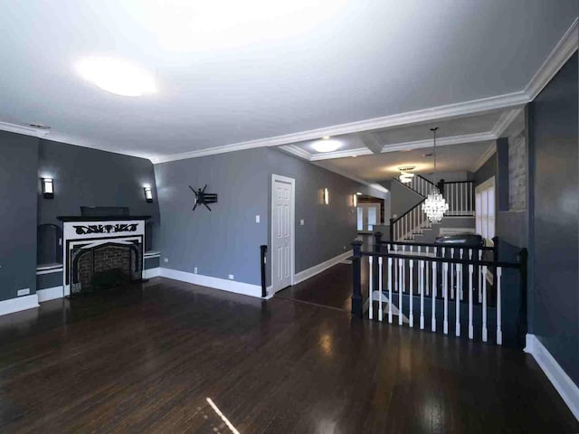 living room with a fireplace with raised hearth, wood finished floors, stairway, crown molding, and baseboards