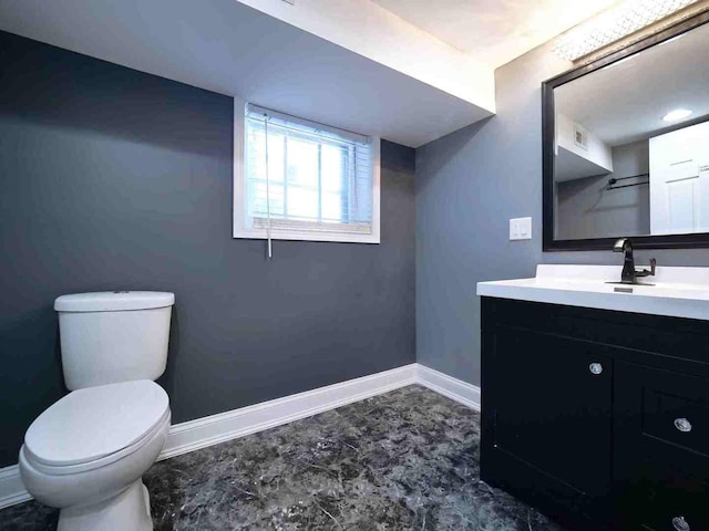 bathroom featuring visible vents, baseboards, toilet, and vanity